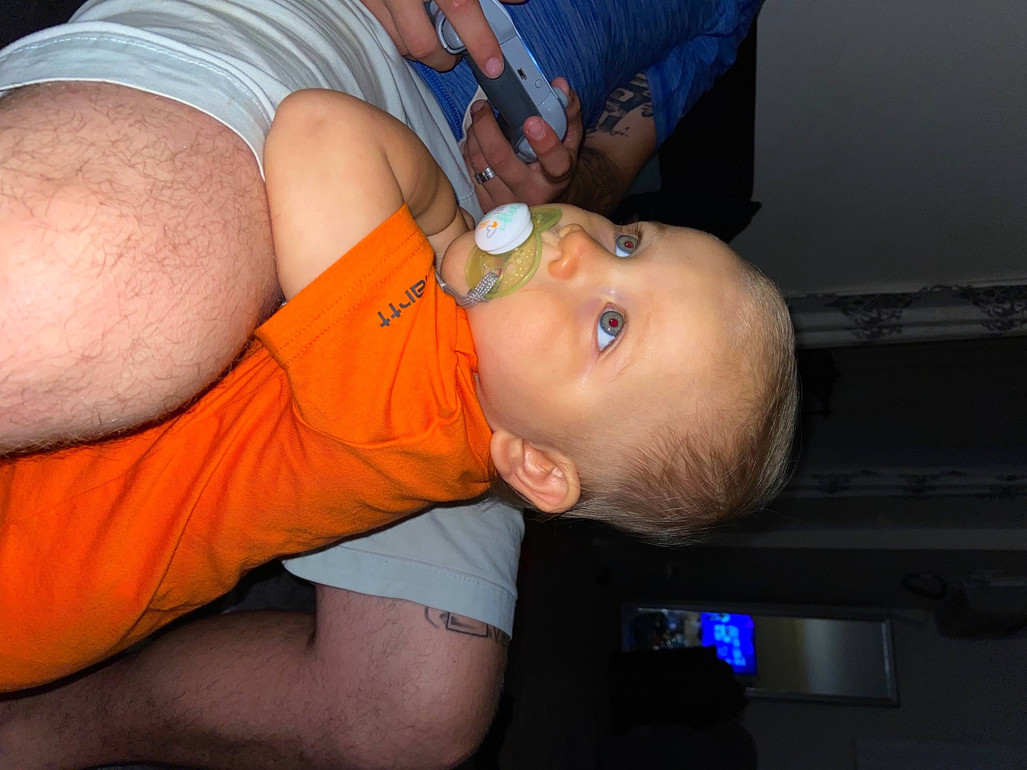 Gerald is registered to the contest to win money with this photo: abdomen, arm, baby, blue, cheek, chest, clothing, elbow, gesture, human_body, joint, leg, mouth, muscle, neck, orange, person, stomach, thigh, toddler