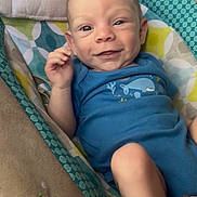 Zander joined the competition — help win amazing prizes! baby, baby_seat, blue_onesie, child, closeup, cushion, cute, eyes, face, hand, happy, head, indoor, infant, patterned_fabric, person, skin, smiling, whale_design, young