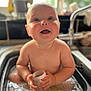 baby, sink, water, container, smile, happy, kitchen, child, cute, sitting, naked, playful, face, blue_eyes, chubby, indoors, clean, wet, young, curious