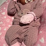 baby, sleeping, pacifier, pink, blanket, mittens, headband, flower, cozy, cute, soft, infant, newborn, clothing, socks, textured, heart_pattern, lying_down, peaceful, portrait