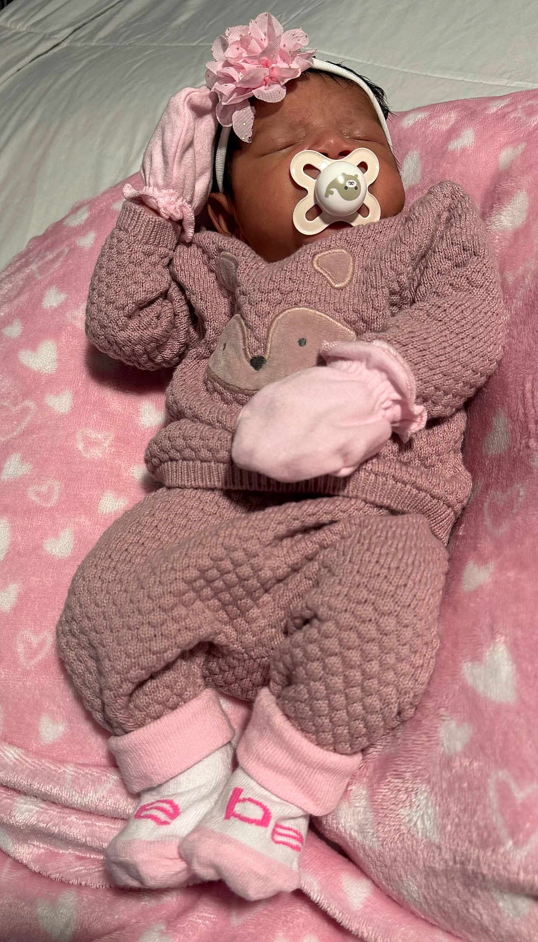 Saira joined the competition — help win amazing prizes! baby, sleeping, pacifier, pink, blanket, mittens, headband, flower, cozy, cute, soft, infant, newborn, clothing, socks, textured, heart_pattern, lying_down, peaceful, portrait