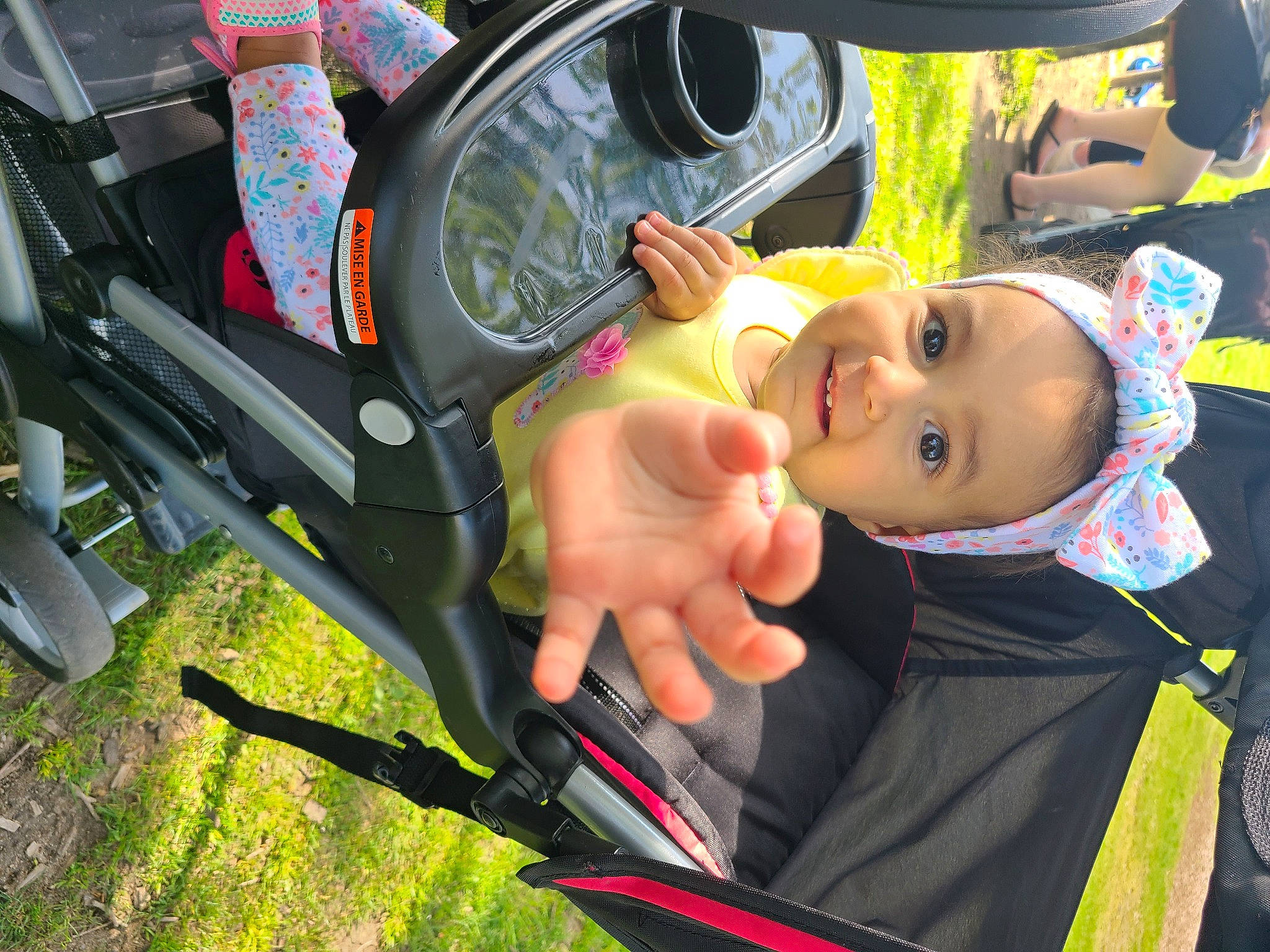Salma joined the competition — help win amazing prizes! automotive_exterior, automotive_lighting, automotive_tire, baby_carriage, car, child, fun, grass, green, happy, leisure, motor_vehicle, person, rim, smile, steering_wheel, tire, toddler, vehicle, vehicle_door