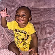 Iyon joined the competition — help win amazing prizes! baby, child, smiling, yellow_shirt, cartoon_character, lion, plush_chair, pink, happy, sitting, indoors, cute, face, hand, feet, person, toddler, clothing, wall, carpet