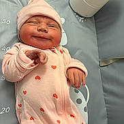 Avalon joined the competition — help win amazing prizes! baby, bedding, cheeks, cozy, face, gray_background, hand, hat, hearts_pattern, infant, lying_down, measuring_mat, newborn, nursery_item, onesie, pink_clothing, portrait, rosy_cheeks, smiling, soft_light