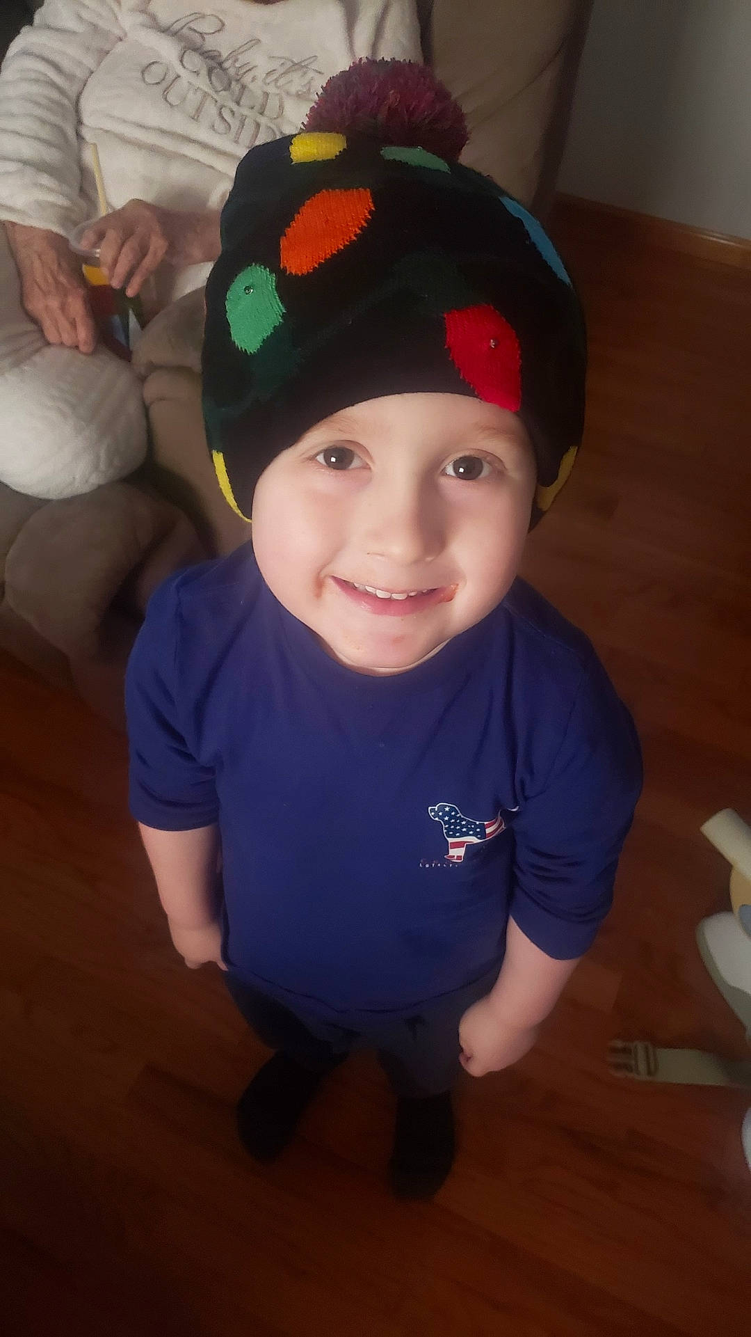 Zane joined the competition — help win amazing prizes! baby_toddler_clothing, baseball_cap, beanie, cap, child, costume_accessory, costume_hat, electric_blue, event, fashion_accessory, flooring, fun, happy, hardwood, headwear, holiday, joy, knit_cap, person, sleeve