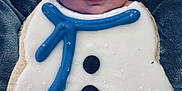 Caspiayn is registered to the contest to win money with this photo: baby, background, blanket, blue_icing, child, closeup, cookie, cute, decorated, face, food, frosting, holiday, icing, portrait, smile, snowman, sweet, toddler, winter