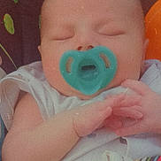 Caspiayn is registered to the contest to win money with this photo: baby, pacifier, sleeping, hands, infant, closeup, face, filter, hearts, black_hearts, colorful_background, clothing, sleeveless, seatbelt, child, cute, resting, indoors, soft_light, portrait
