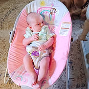 Sawyer is registered to the contest to win money with this photo: baby, infant, bouncer, pink, rainbow, monkey, carpet, dog, playful, indoor, foot, patterned, cute, child, seated, clothing, toy, animal, person, home