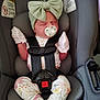 baby, infant, car_seat, pacifier, headband, bow, mittens, floral_clothing, safety_harness, child, cute, sleeping, newborn, pink, white, patterned_clothing, seat_belt, transportation, car, young_child