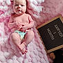 baby, infant, diaper, pink_blanket, fluffy_blanket, sign_board, milestone, one_month, face, expression, hands, feet, plush_toy, soft_texture, cute, newborn, portrait, lying_down, skin, child