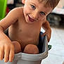 Meyson a rejoint le concours — aidez-le/la à gagner de superbes lots ! child, toddler, smiling, blue_eyes, indoor, plastic_bin, playful, bare_chest, happy, person, floor, hand, legs, brown_hair, fun, cute, expression, holding, sitting, container