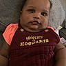 Chanelle joined the competition — help win amazing prizes! baby, child, chubby_cheeks, closeup, clothing, couch, curious_expression, cute, eyes, fabric, face, indoors, infant, lying_down, maroon_outfit, pink_shirt, portrait, soft_texture, text_on_clothing, young_child