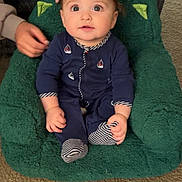 Jaxon joined the competition — help win amazing prizes! baby, child, infant, onesie, blue_clothing, green_chair, carpet, indoor, person, hands, support, cute, wide_eyes, sitting, plush_chair, portrait, young_child, comfort, looking_up, casual