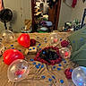 cat, black_cat, pet, animal, bed, bedroom, balloons, red_balloon, clear_balloon, roses, rose_petals, romantic, celebration, party, gift, blue_confetti, blanket, home_interior, cluttered_room, relaxed