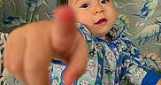 Ocean joined the competition — help win amazing prizes! toddler, child, pajamas, bunny_pattern, dinosaur_pattern, curious, pointing, indoor, bedroom, blanket, cute, portrait, young_child, playful, colorful, soft_lighting, face, hand, expression, cozy