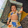Ocean joined the competition — help win amazing prizes! toddler, child, pajamas, animal_print, dinosaur_pattern, chair, carpet, indoor, relaxed, colorful_clothing, face, person, furniture, floor, home, portrait, casual, cute, baby, resting