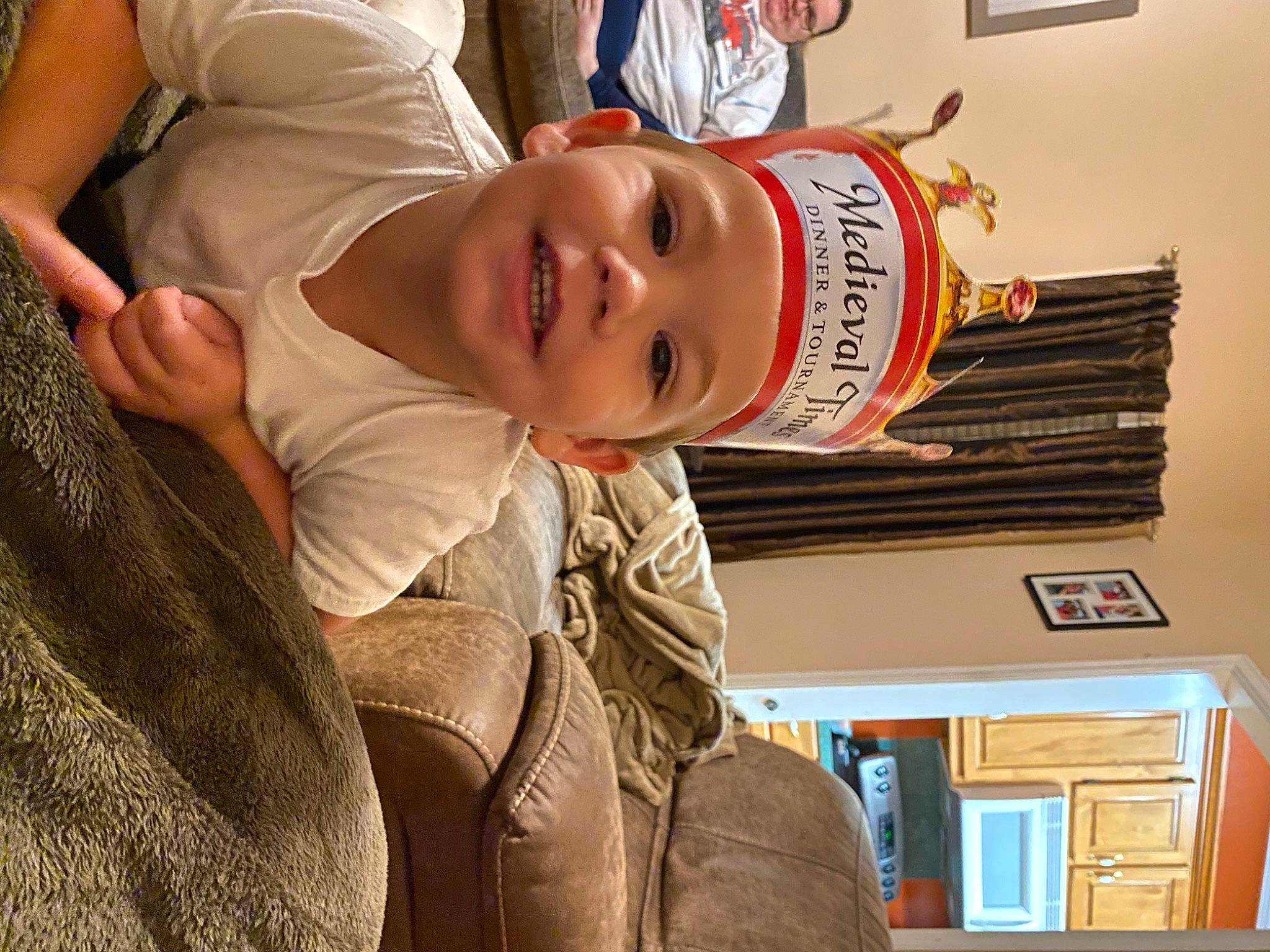 Callen is registered to the contest to win money with this photo: baby, child, fun, fur, happy, hat, headgear, headwear, joy, person, picture_frame, room, smile, t_shirt, toddler