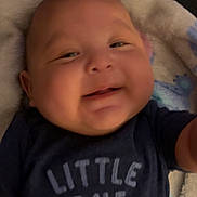Dominic joined the competition — help win amazing prizes! baby, blanket, blue_shirt, child, clothing, cozy, cute, expression, face, happy, head, indoor, infant, lying_down, portrait, skin, smile, soft_texture, toddler, young_child