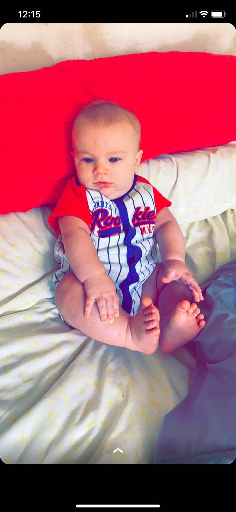 Aiden is registered to the contest to win money with this photo: arm, baby, baby_toddler_clothing, cheek, child, comfort, couch, electric_blue, finger, hand, happy, iris, nail, person, pink, purple, sitting, skin, textile, thumb