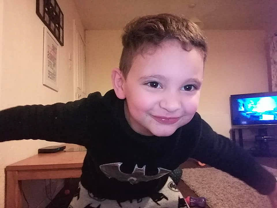 Amari is registered to the contest to win money with this photo: cheek, child, cool, display_device, finger, flooring, fun, hairstyle, happy, jaw, joy, person, sitting, sleeve, smile, standing, t_shirt, television, television_set, thumb