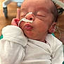 Daxton is registered to the contest to win money with this photo: baby, newborn, infant, sleeping, puckered_lips, nasal_tube, medical_tape, onesie, hand, face, head, hair, skin, hospital, medical_equipment, wheel, closeup, portrait, indoors, peaceful