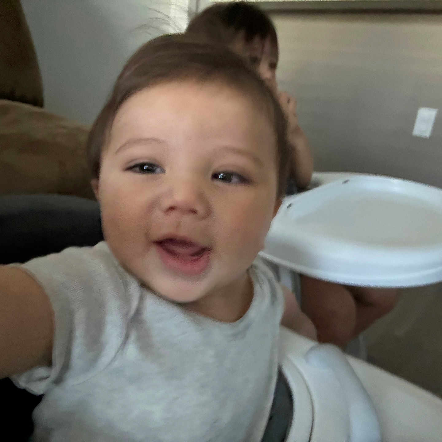 Jairo joined the competition — help win amazing prizes! arm, baby, background, child, clothing, face, floor, furniture, happy, head, high_chair, indoor, person, playful, room, seat, smiling, table, toddler, wall