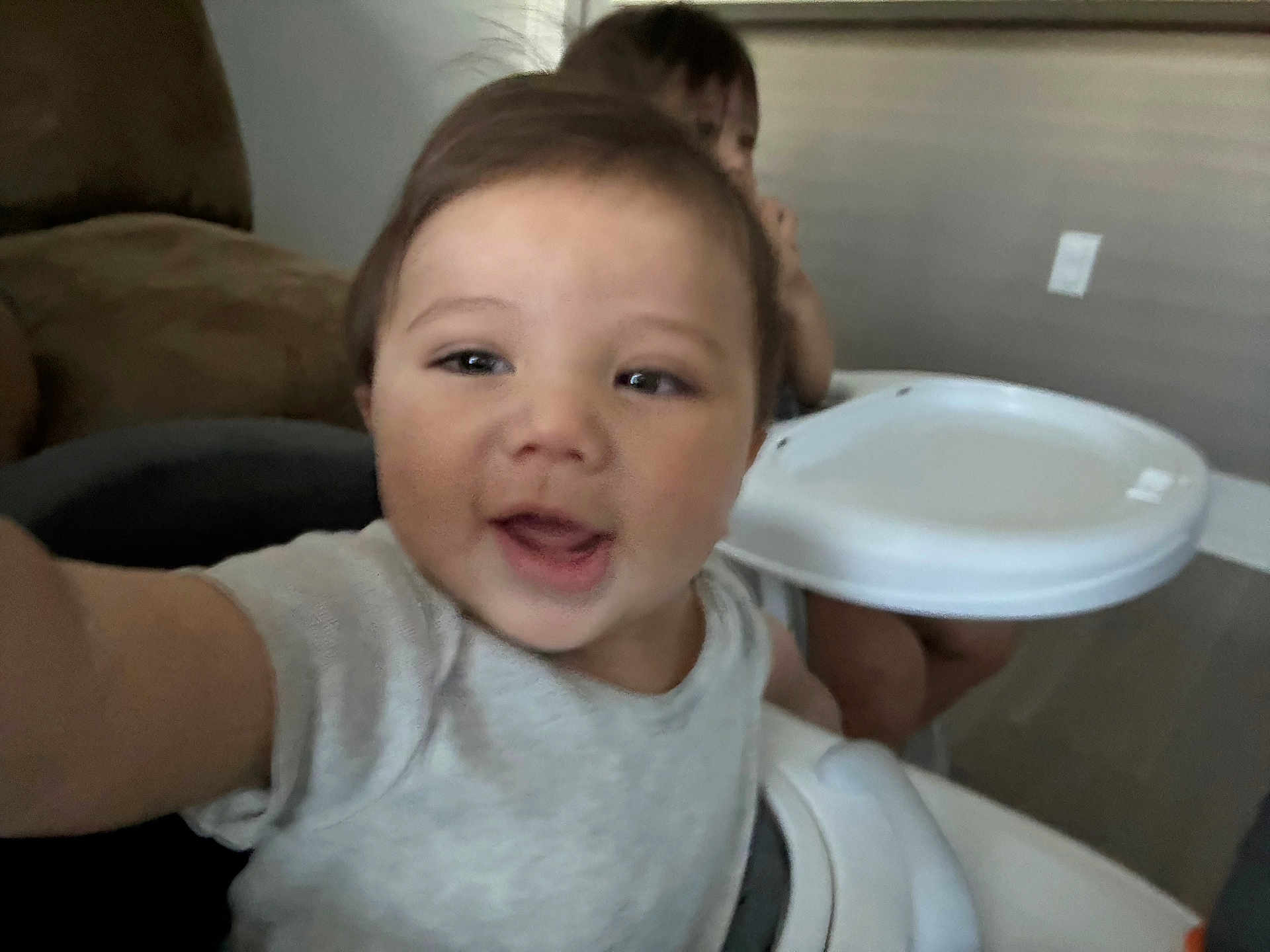 Jairo joined the competition — help win amazing prizes! child, toddler, high_chair, indoor, happy, smiling, person, face, baby, furniture, table, seat, clothing, arm, head, background, room, wall, floor, playful