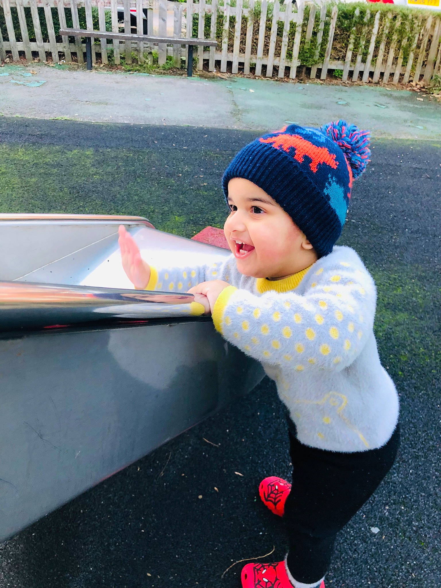 Azlan is registered to the contest to win money with this photo: asphalt, automotive_exterior, automotive_tire, automotive_wheel_system, beanie, cap, child, city, fun, grass, hat, headwear, knit_cap, leisure, magenta, person, personal_protective_equipment, plant, play, recreation