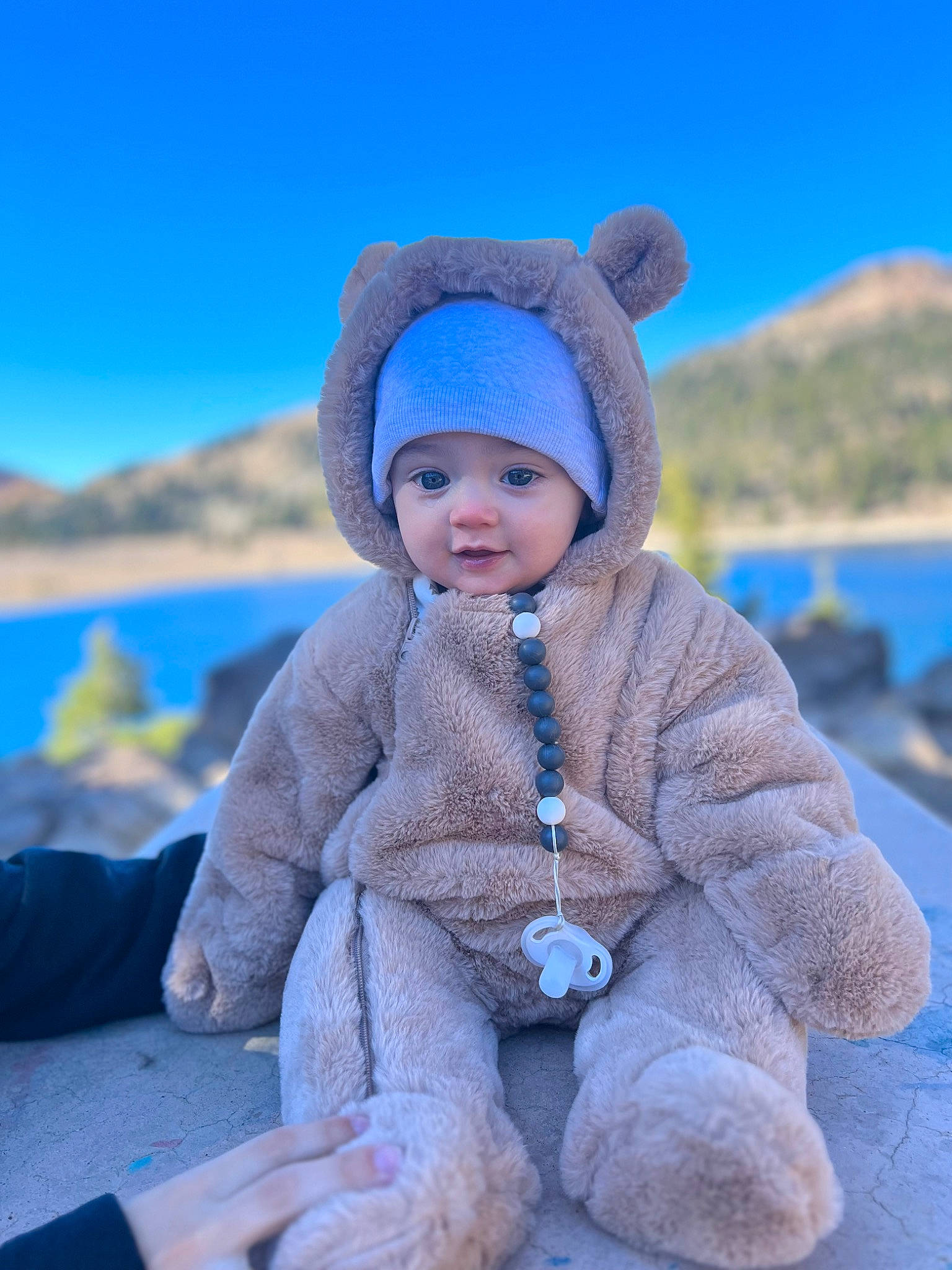 Elio joined the competition — help win amazing prizes! baby, baby_toddler_clothing, child, electric_blue, freezing, fun, happy, headwear, hood, jacket, lake, landscape, leisure, mountain, outerwear, person, recreation, sky, sleeve, toddler