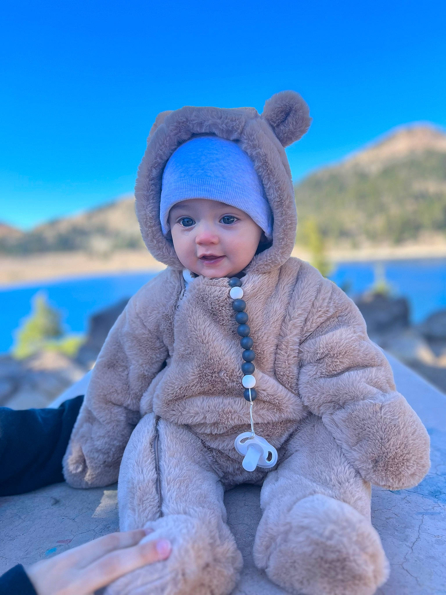 Elio joined the competition — help win amazing prizes! baby, baby_toddler_clothing, electric_blue, eye, face, freezing, fun, happy, headwear, hood, lake, landscape, leisure, mountain, person, recreation, skin, sky, sleeve, toddler