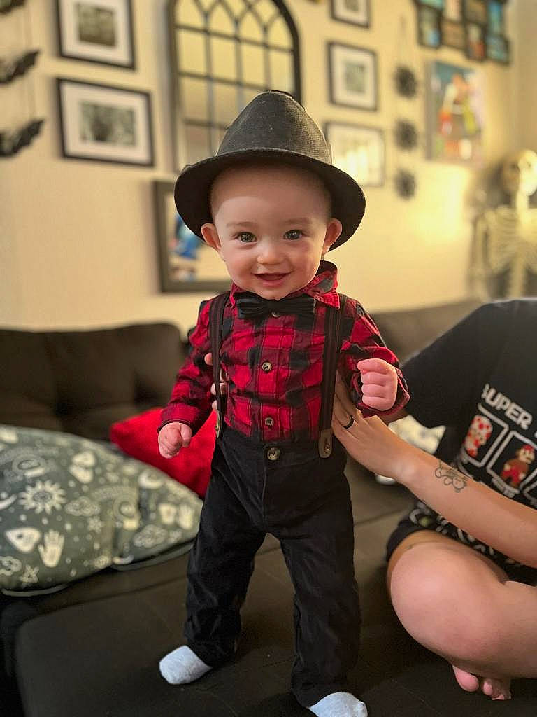 Elio joined the competition — help win amazing prizes! child, couch, event, fashion_accessory, fun, happy, hat, human_leg, joy, knee, pattern, person, picture_frame, plaid, room, sitting, sleeve, smile, sock, sun_hat