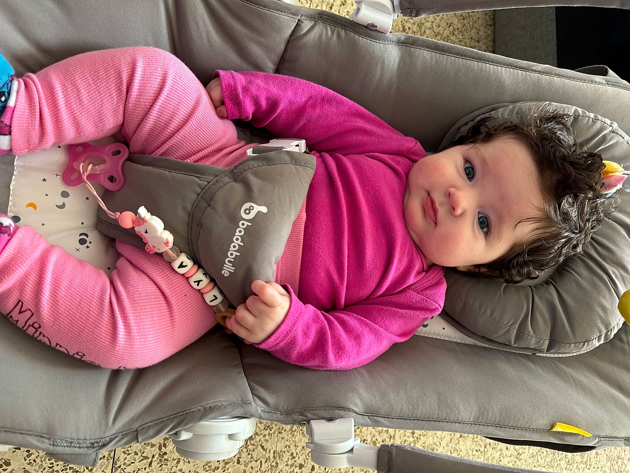 Lya a rejoint le concours — aidez-le/la à gagner de superbes lots ! baby, baby_products, child, comfort, couch, fun, grass, human_leg, knee, lap, magenta, outerwear, person, pink, purple, sitting, sleeve, textile, thigh, toddler