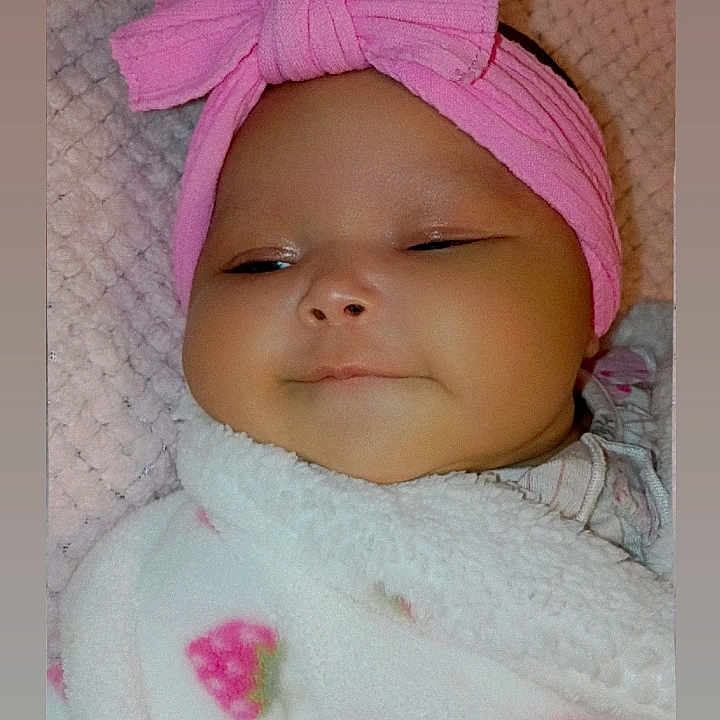 Lavaeh joined the competition — help win amazing prizes! baby, infant, pink_headband, blanket, strawberry_pattern, cozy, cute, smiling, face, headwear, child, portrait, soft_texture, sleepy, indoors, closeup, adorable, young_child, comfort, wrapped