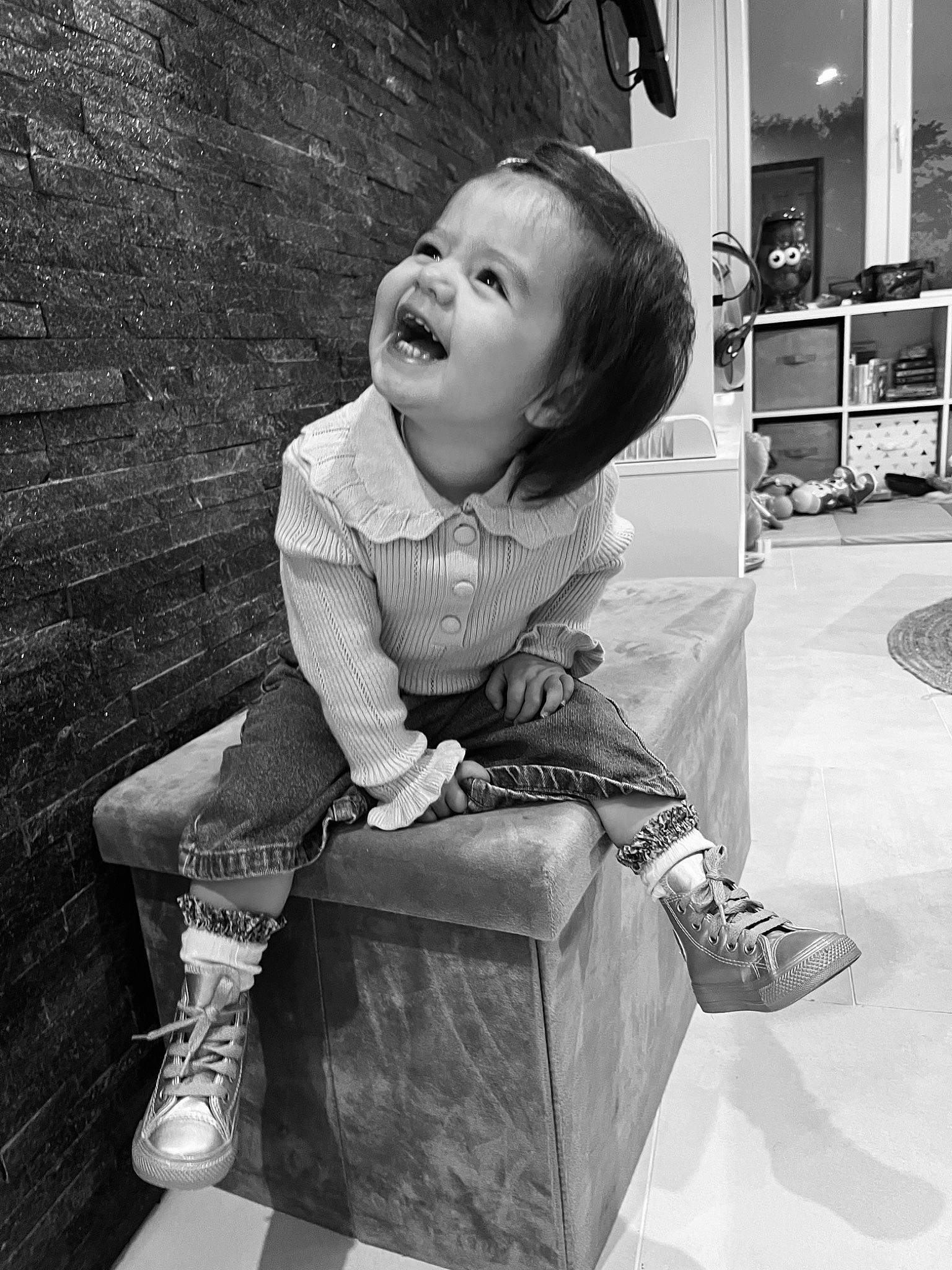 Nina participe au concours pour gagner de l'argent avec cette photo : baby, black, black_and_white, child, flash_photography, happy, monochrome, monochrome_photography, people, person, photograph, shelf, sitting, smile, snapshot, sneakers, standing, stock_photography, style, toddler