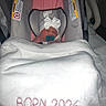 newborn, baby, car_seat, blanket, pacifier, hat, sleeping, indoors, infant, white_blanket, pink_car_seat, baby_clothing, headwear, child, portrait, baby_accessory, soft_texture, resting, cozy, wrapped