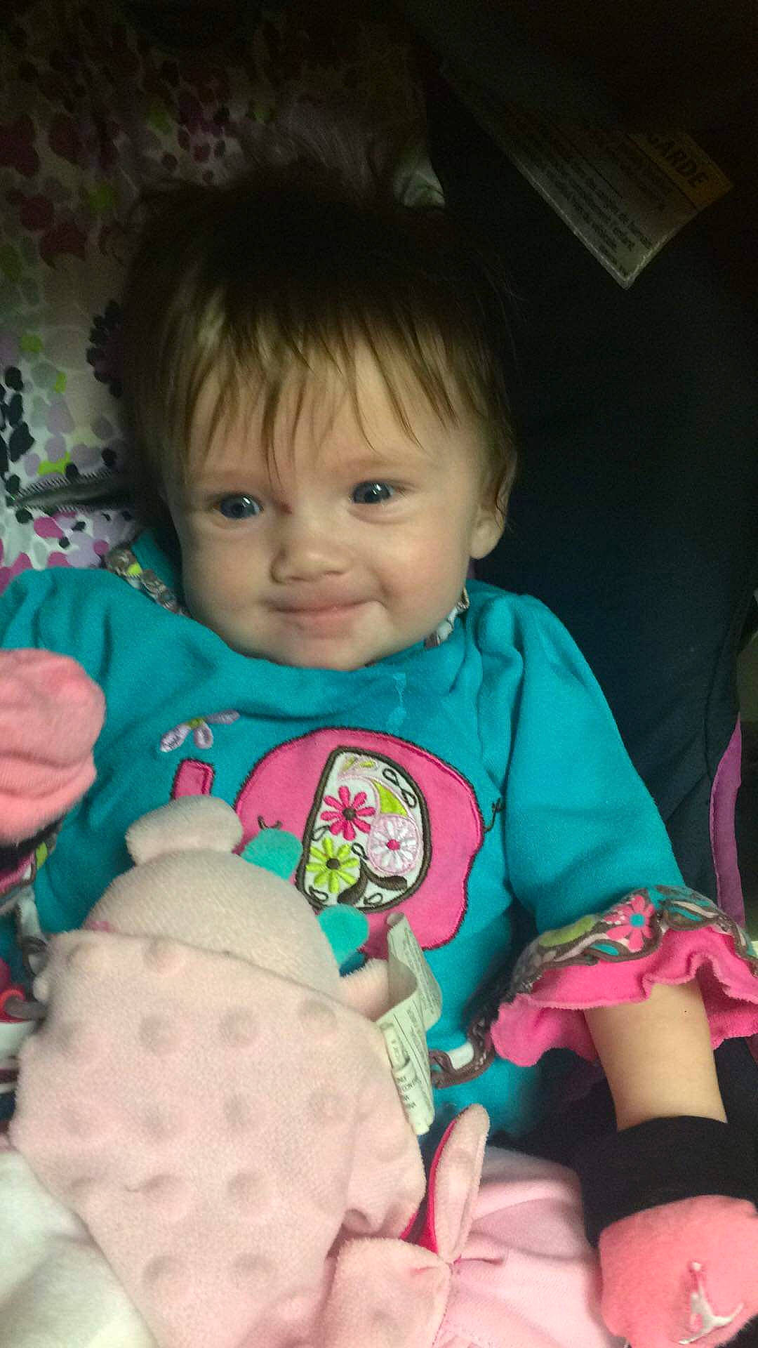 Kaylin is registered to the contest to win money with this photo: baby, cheek, child, ear, eye, face, fun, head, iris, lip, person, pink, play, sitting, skin, smile, stuffed_toy, toddler