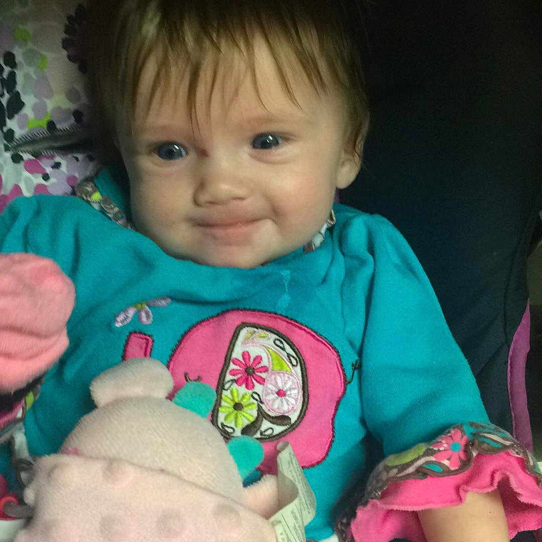 Kaylin is registered to the contest to win money with this photo: baby, cheek, child, ear, eye, face, fun, head, iris, lip, person, pink, play, sitting, skin, smile, stuffed_toy, toddler