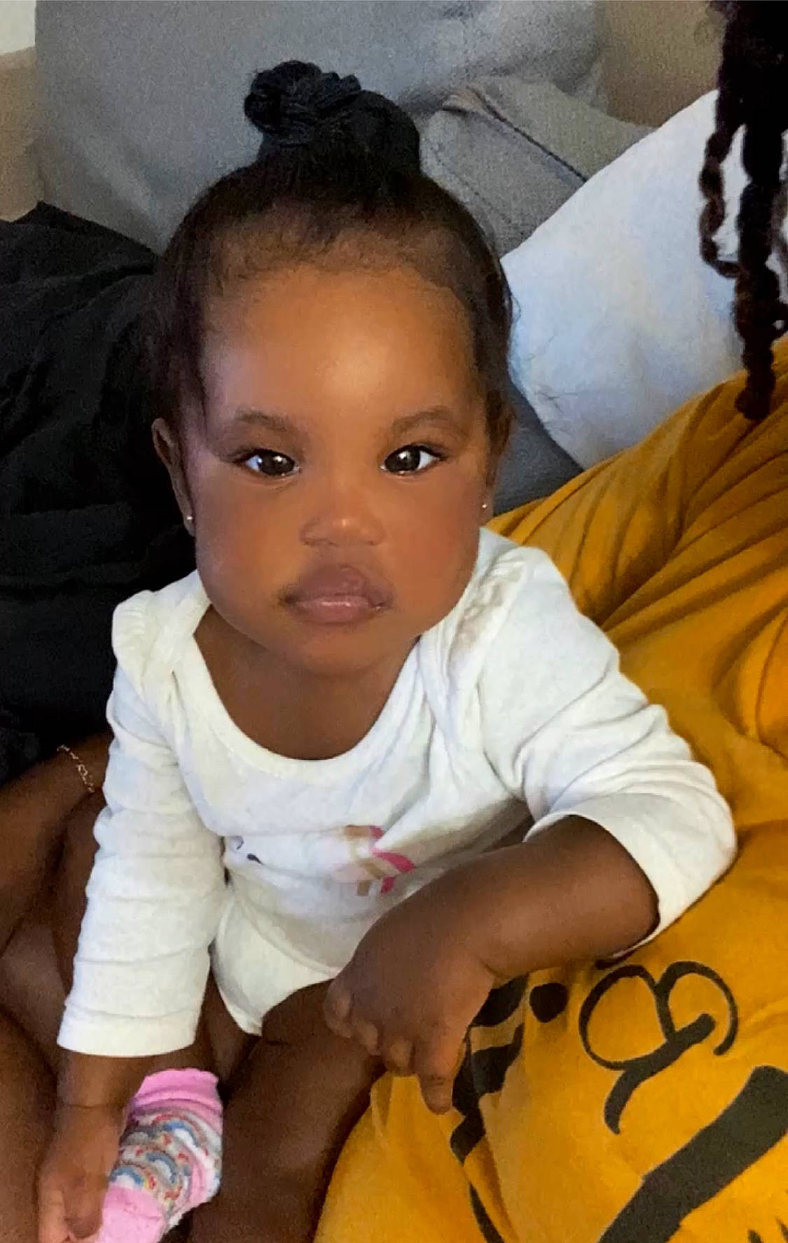 Egypt is registered to the contest to win money with this photo: baby_toddler_clothing, black_hair, cheek, chin, comfort, eye, eyelash, finger, forehead, hair, happy, head, iris, mouth, nose, person, skin, sleeve, smile, toddler