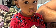 Amarii joined the competition — help win amazing prizes! toddler, child, indoor, person, red_shirt, spiderman, cards, curly_hair, earring, diaper, blanket, bed, arm, expression, holding, sitting, face, clothing, home, curious