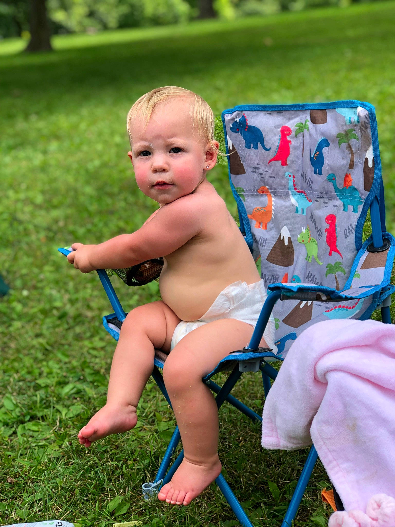 Eleanor is registered to the contest to win money with this photo: baby, barefoot, chair, child, folding_chair, foot, fun, grass, grass_family, human_leg, lap, lawn, leisure, outdoor_furniture, people_in_nature, person, plant, recreation, shorts, thigh