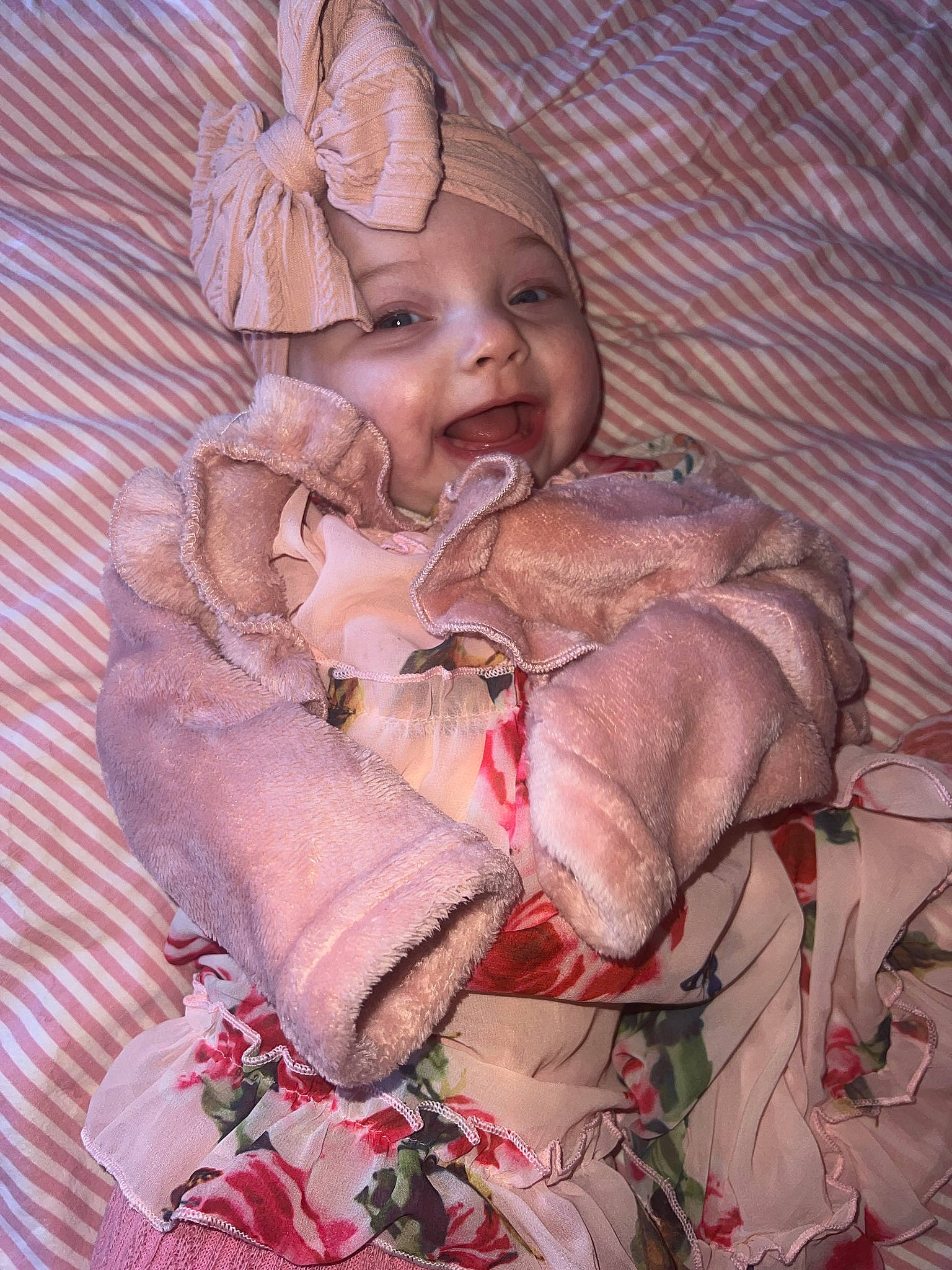 Noelle is registered to the contest to win money with this photo: baby, baby_products, baby_toddler_clothing, child, comfort, doll, fur, hand, happy, headwear, linens, lip, nail, pattern, peach, person, petal, pink, sitting, skin