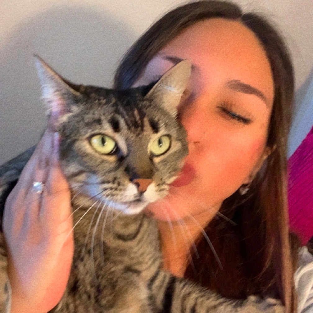 Kim Cece Daisy joined the competition — help win amazing prizes! blur, cat, close_up, cuddling, green_eyes, hand, holding, human_face, indoor, kiss, long_hair, person, pet, portrait, ring, sofa, tabby, tabby_cat, wall, whiskers