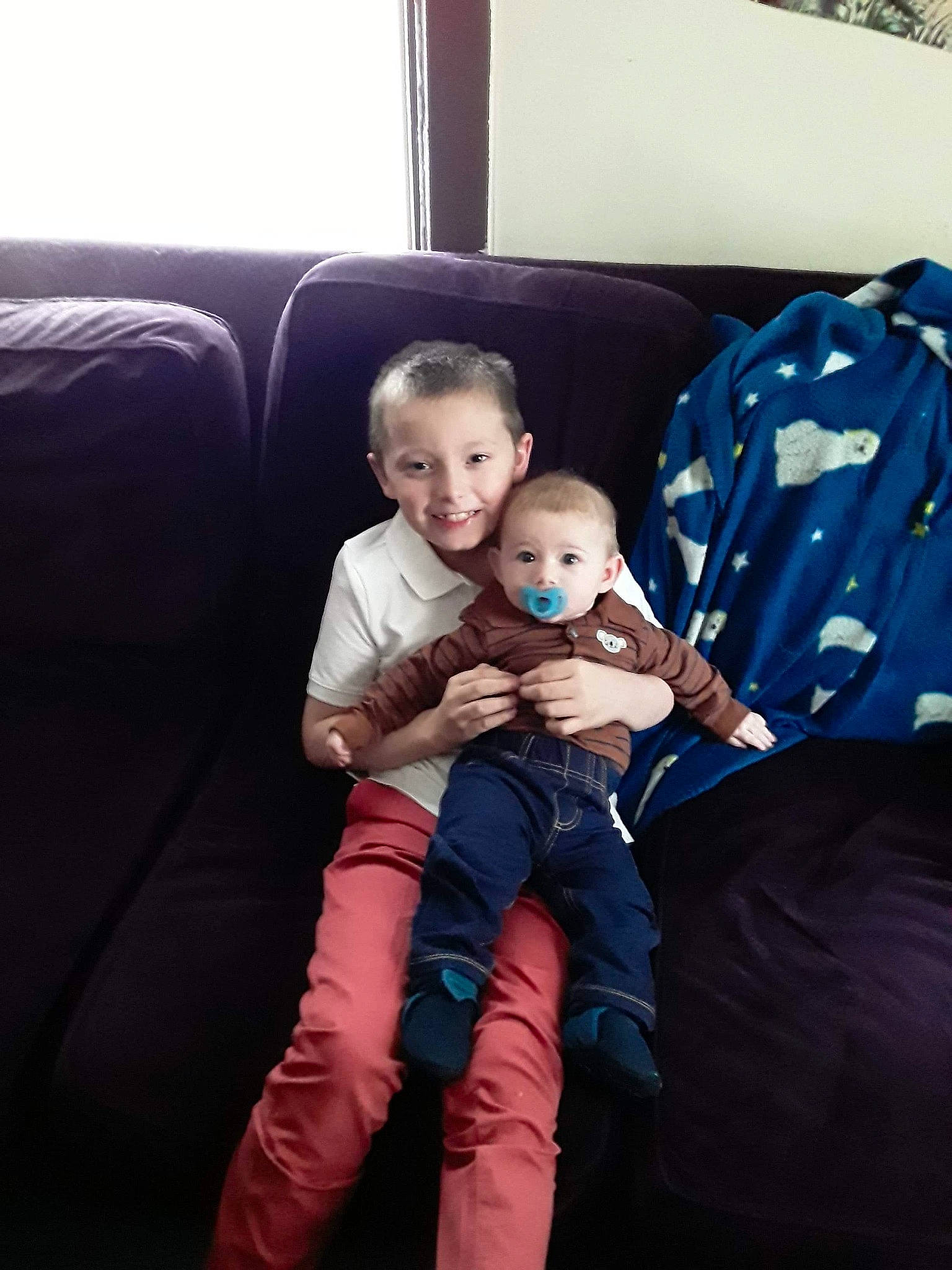 Colton is registered to the contest to win money with this photo: baby, child, comfort, couch, eye, family, furniture, head, joy, lap, leg, people, person, play, sibling, sitting, skin, smile, snapshot, toddler