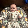 baby, babylaughing, blanket, clothing, couch, cushion, face, furniture, happy, head, homedecor, newborn, pajamas, person, photography, portrait, quilt, sitting, sleeve, smile