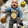 baby, bed, clothing, couch, face, food, fruit, furniture, happy, head, pants, person, photography, plant, portrait, produce, pumpkin, squash, vegetable, yawning