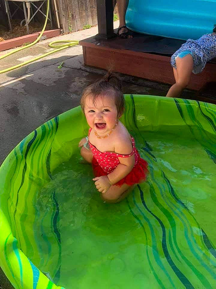 Charleigh joined the competition — help win amazing prizes! aqua, baby, baby_toddler_clothing, barefoot, bathing, blue, child, event, fun, grass, green, leisure, outdoor_furniture, person, pink, product, recreation, smile, summer, toddler