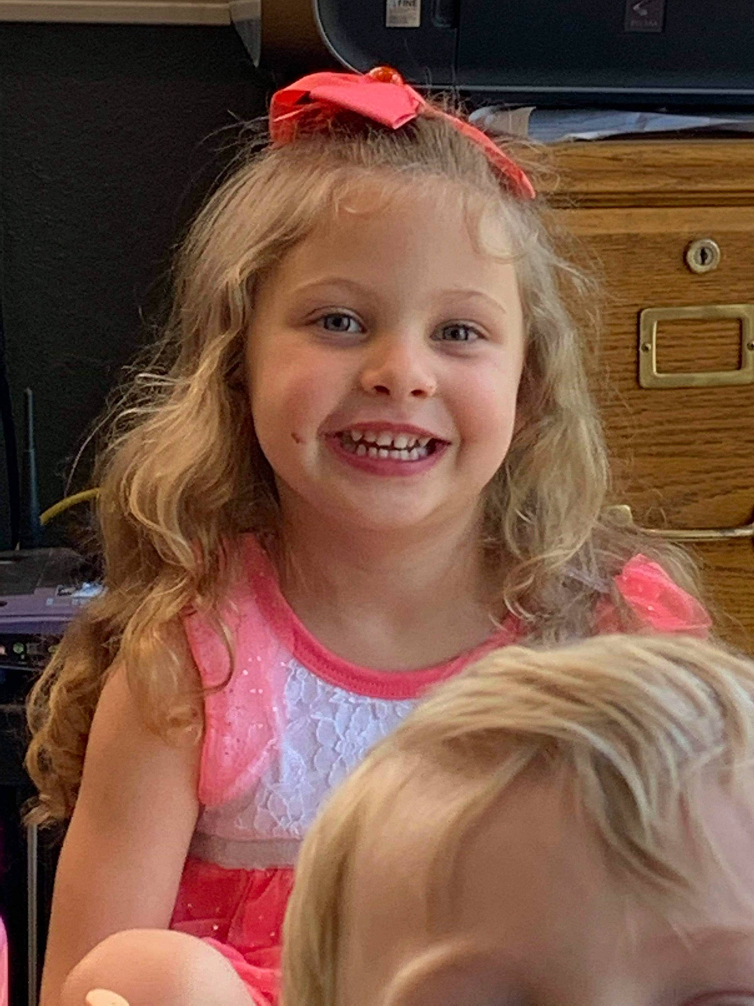 Seraphina is registered to the contest to win money with this photo: cabinetry, cheek, chin, drawer, eyebrow, facial_expression, hair, hairstyle, happy, head, iris, joy, lip, mammal, muscle, organ, person, pink, skin, smile