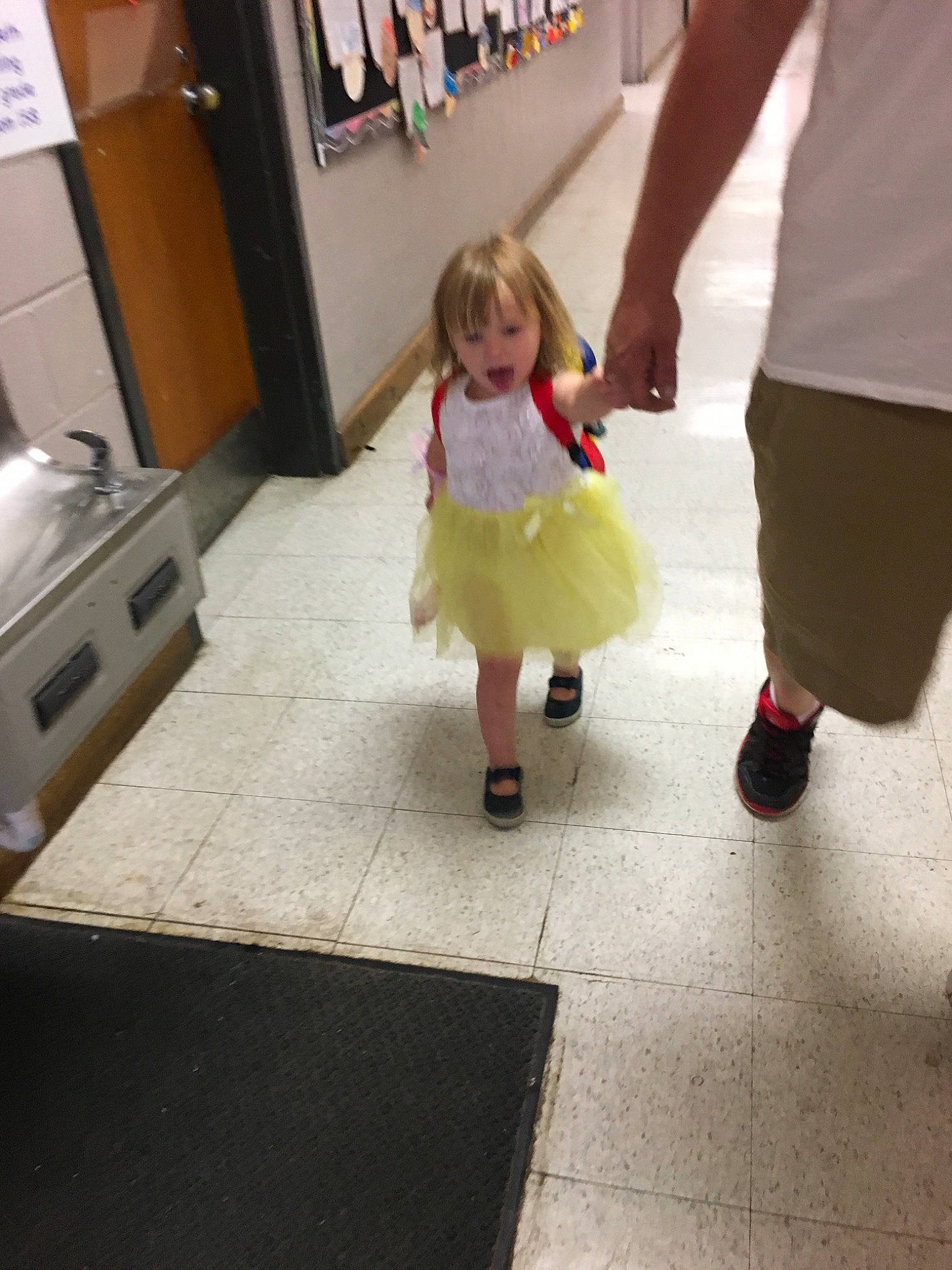 Letty is registered to the contest to win money with this photo: child, daughter, dress, floor, flooring, footwear, human_leg, leg, person, play, shoe, snapshot, standing, toddler, vacation, walking, yellow