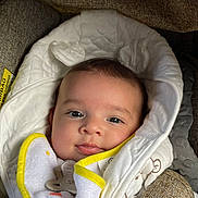 Maīna a rejoint le concours — aidez-le/la à gagner de superbes lots ! baby, blanket, pacifier, cushion, face, infant, smile, clothing, fabric, seat, closeup, head, child, portrait, cozy, soft, indoor, comfort, cute, young