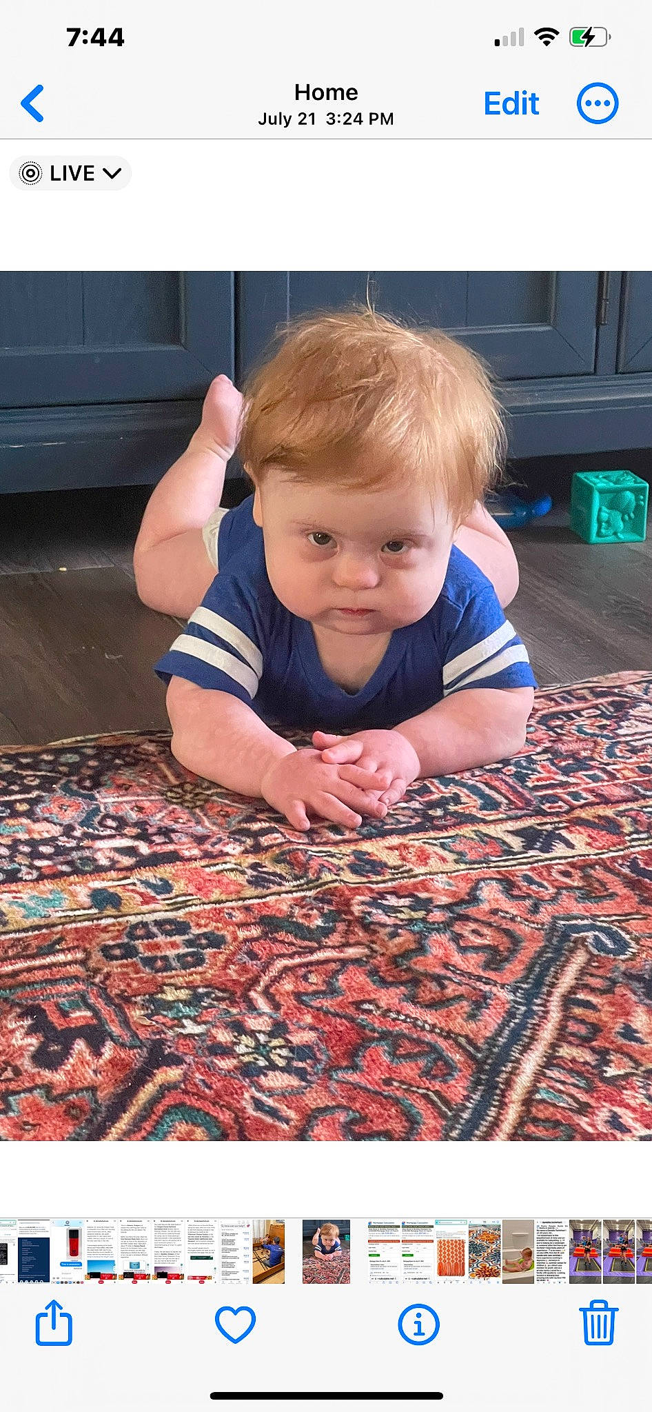 Owen is registered to the contest to win money with this photo: baby, baby_toddler_clothing, black, carpet, child, crawling, electric_blue, floor, flooring, fun, hair, hardwood, linens, mat, pattern, person, rug, sitting, t_shirt, toddler